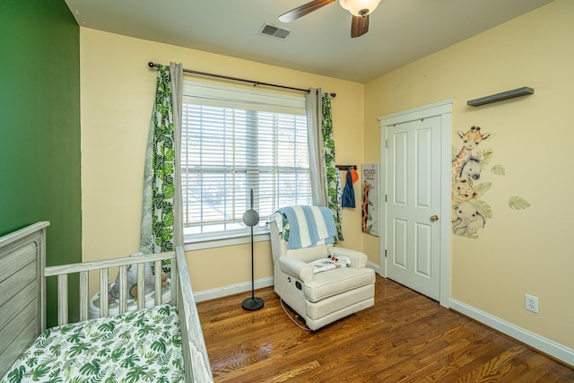 sitting room with dark hardwood / wood-style floors and ceiling fan