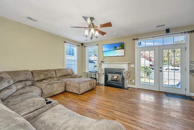 living room featuring french doors, hardwood / wood-style flooring, and ceiling fan