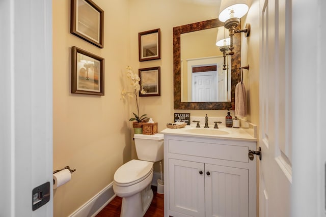 bathroom with vanity, hardwood / wood-style flooring, and toilet