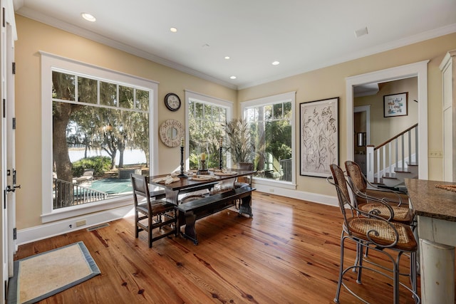 dining room featuring crown molding and light wood-type flooring