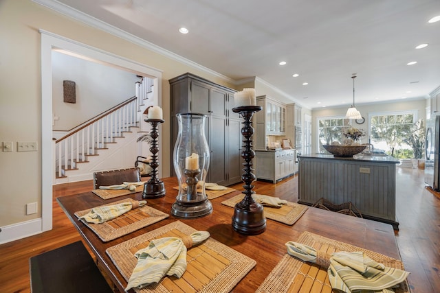 dining area featuring crown molding and wood-type flooring