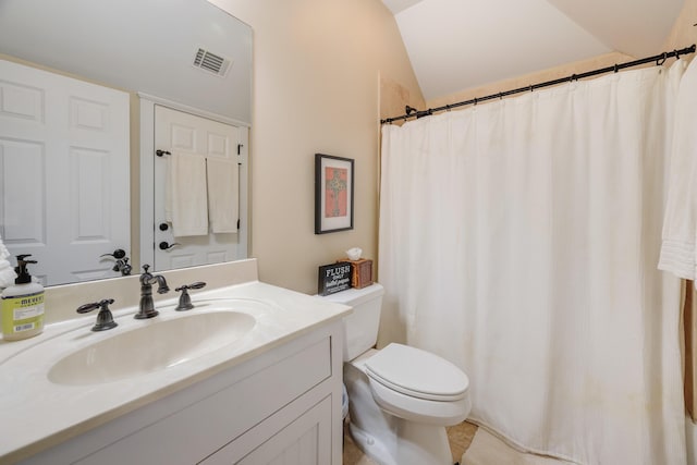 bathroom featuring toilet, vanity, and vaulted ceiling