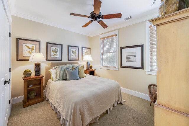 carpeted bedroom featuring ceiling fan and ornamental molding