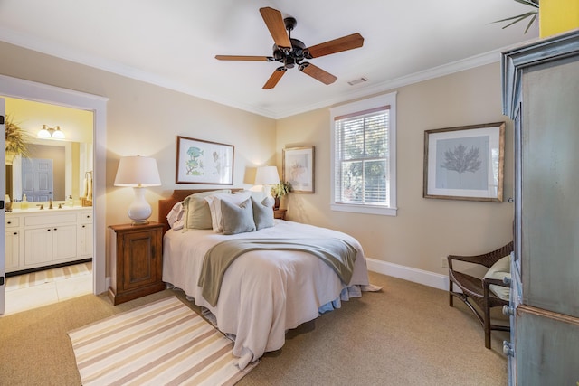 bedroom featuring ceiling fan, sink, ensuite bathroom, crown molding, and light colored carpet