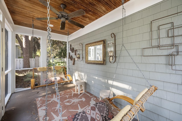 sunroom / solarium with ceiling fan and wooden ceiling