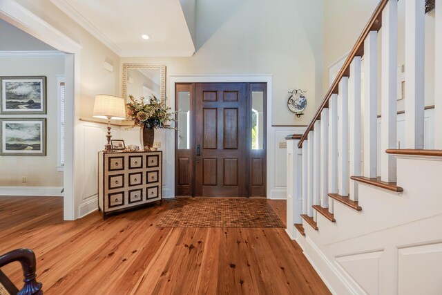 foyer with crown molding and hardwood / wood-style flooring