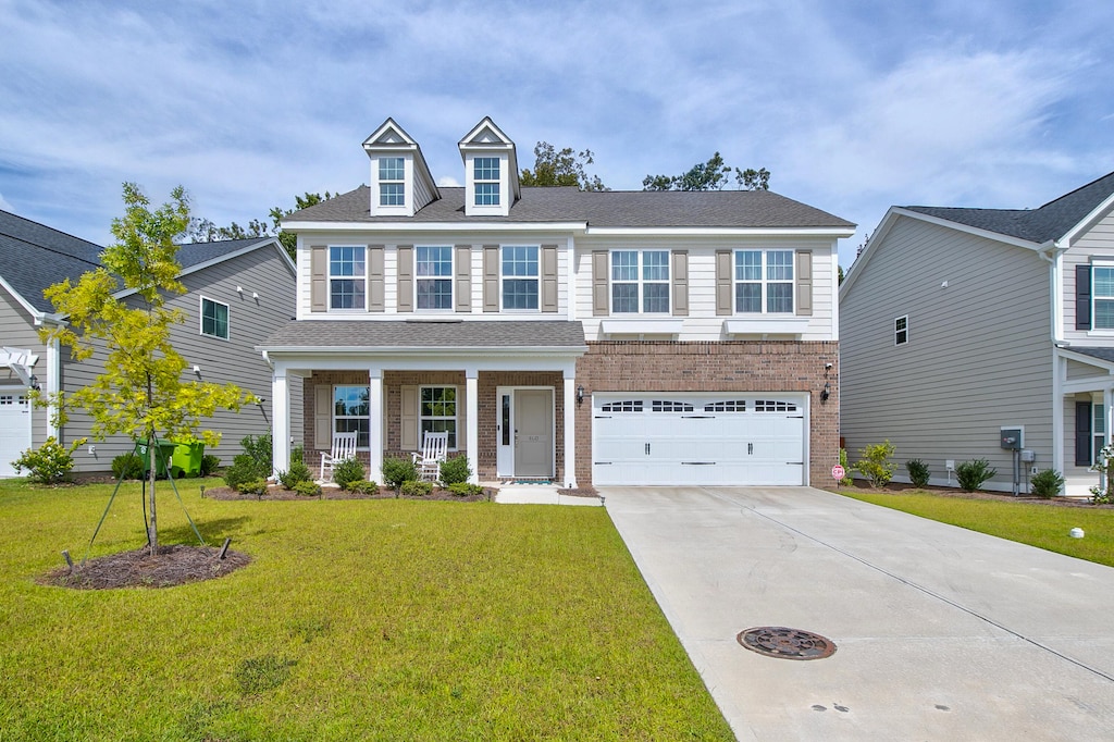 view of front of home with a front yard and a garage