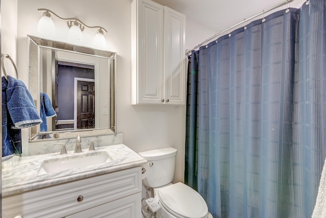 bathroom featuring vanity, a shower with curtain, and toilet