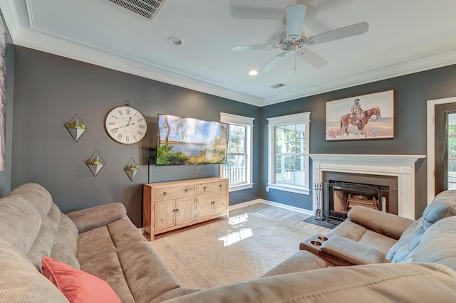 living area featuring ornamental molding, a ceiling fan, and visible vents