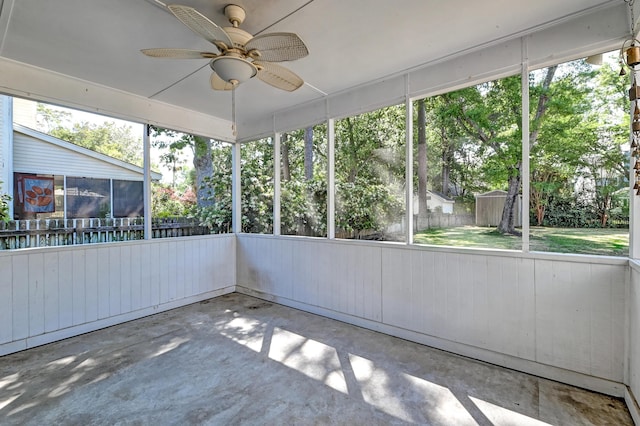 unfurnished sunroom with a ceiling fan