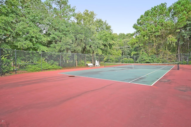 view of tennis court with fence and community basketball court