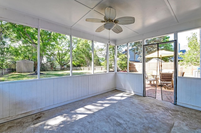 unfurnished sunroom featuring ceiling fan