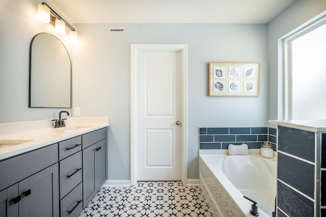 224 Wappoo Trace Ln, Summerville, SC 29486 - bathroom with double vanity, a garden tub, tile patterned floors, and baseboards
