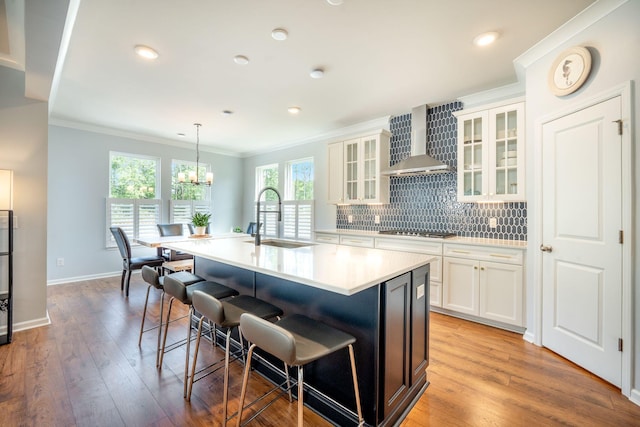 224 Wappoo Trace Ln, Summerville, SC 29486 - kitchen featuring a sink, wall chimney range hood, a kitchen bar, cooktop, and ornamental molding