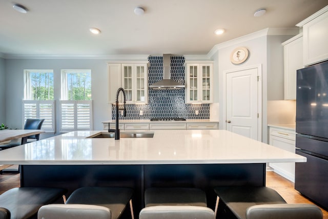 224 Wappoo Trace Ln, Summerville, SC 29486 - kitchen with wall chimney exhaust hood, freestanding refrigerator, a breakfast bar, decorative backsplash, and ornamental molding