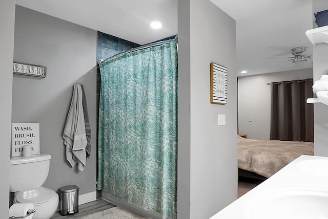 bathroom featuring a shower with curtain, hardwood / wood-style flooring, ceiling fan, and toilet