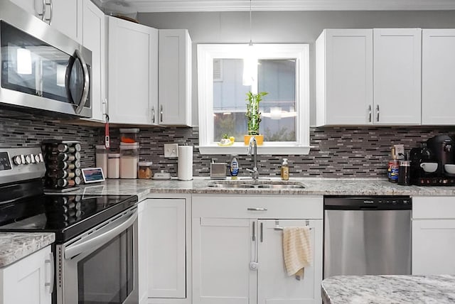 kitchen with white cabinets, sink, appliances with stainless steel finishes, and tasteful backsplash