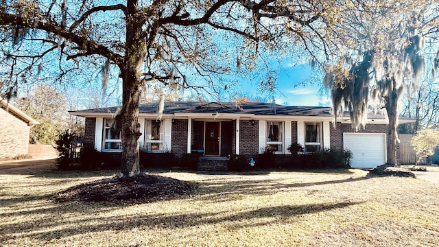 ranch-style house with a garage and a front lawn