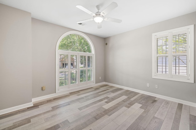1232 Palmetto Peninsula Dr, Mount Pleasant, SC 29464 - empty room with healthy amount of natural light, light wood-type flooring, ceiling fan, and baseboards