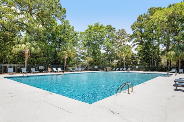 1232 Palmetto Peninsula Dr, Mount Pleasant, SC 29464 - community pool featuring fence, a patio, and view of wooded area