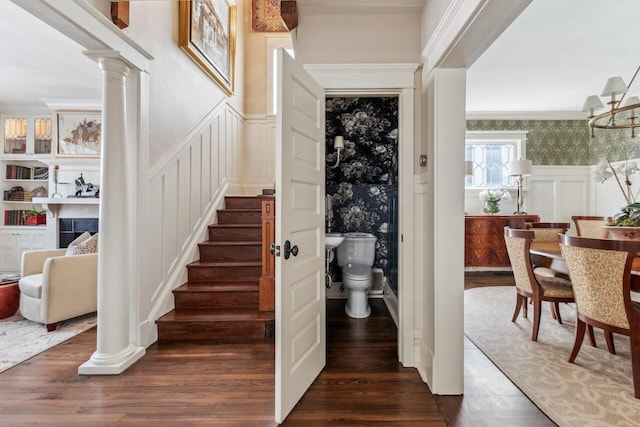 interior space featuring ornate columns and dark hardwood / wood-style flooring