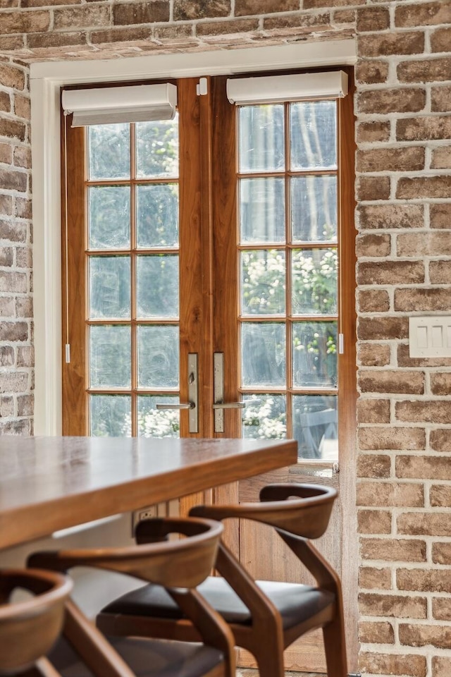 dining area featuring brick wall