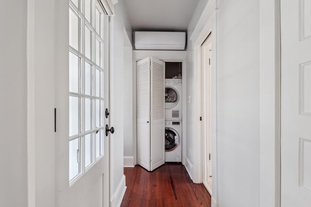 clothes washing area with stacked washer / dryer, dark hardwood / wood-style floors, and a wall mounted AC