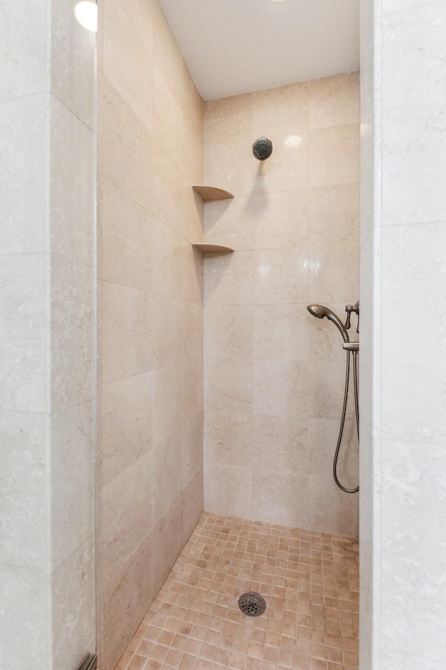 bathroom with a tile shower