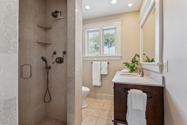 bathroom featuring tile patterned flooring, vanity, toilet, and a shower with shower door