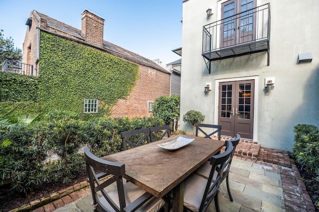 view of patio featuring a balcony and french doors