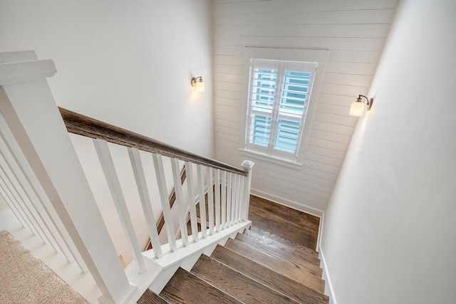 stairway with baseboards and wood finished floors