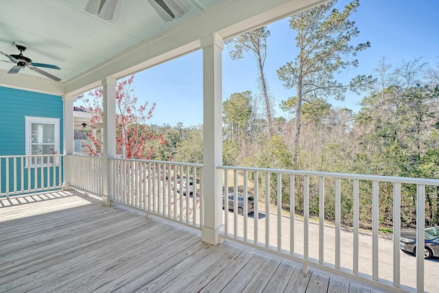 wooden deck featuring a ceiling fan