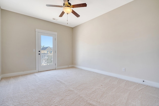 spare room with baseboards, ceiling fan, visible vents, and light colored carpet