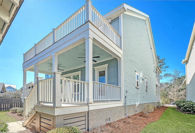 view of property exterior with a balcony, ceiling fan, stairway, crawl space, and a porch