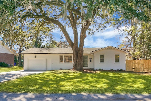 ranch-style house featuring a garage and a front yard