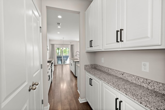 interior space with sink, an inviting chandelier, and dark hardwood / wood-style floors