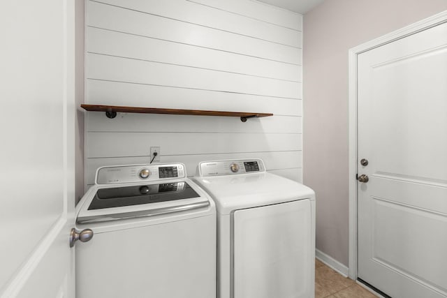 washroom with light tile patterned floors and washing machine and clothes dryer