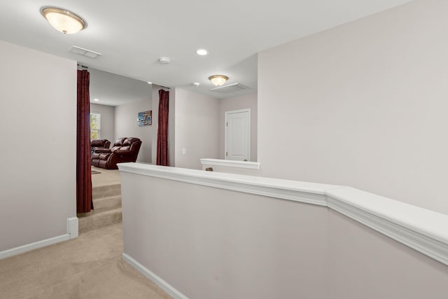 hallway with light colored carpet