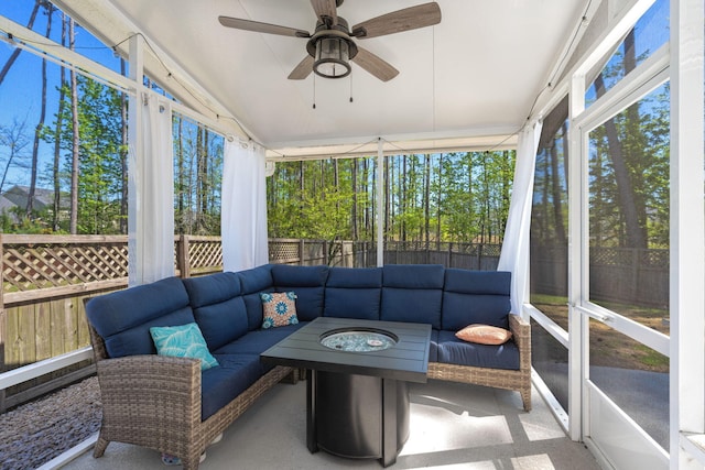 sunroom with lofted ceiling, a healthy amount of sunlight, and ceiling fan