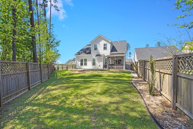 rear view of property featuring a yard