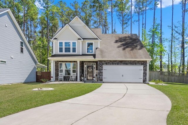 craftsman inspired home with a garage, a front yard, and a porch