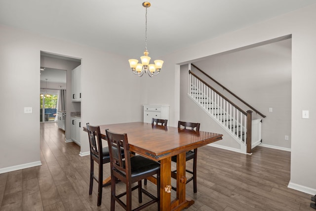 dining area featuring a notable chandelier and dark hardwood / wood-style flooring