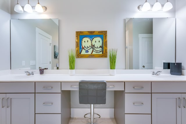 bathroom featuring a sink and double vanity