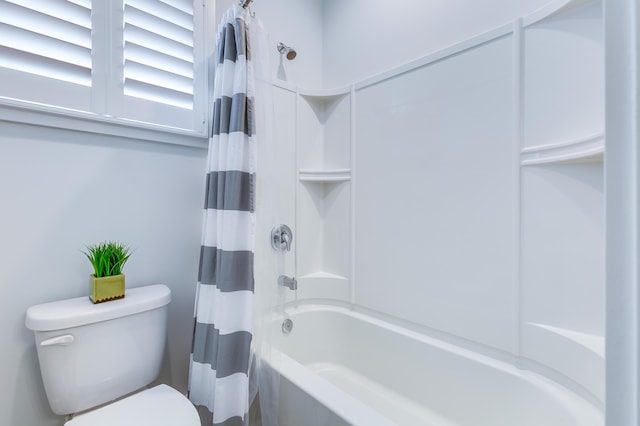 bathroom featuring shower / bathtub combination with curtain and toilet