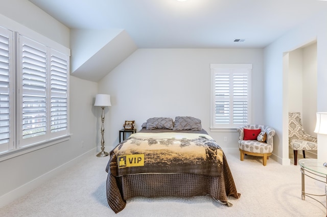 carpeted bedroom with vaulted ceiling, multiple windows, and baseboards