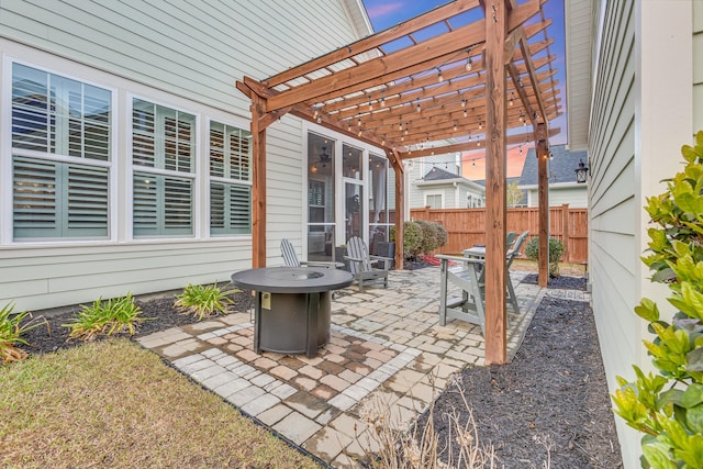 view of patio / terrace featuring a sunroom, fence, and a pergola