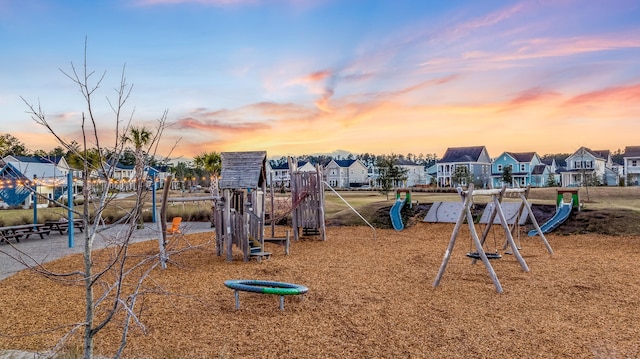 playground at dusk featuring a residential view and playground community