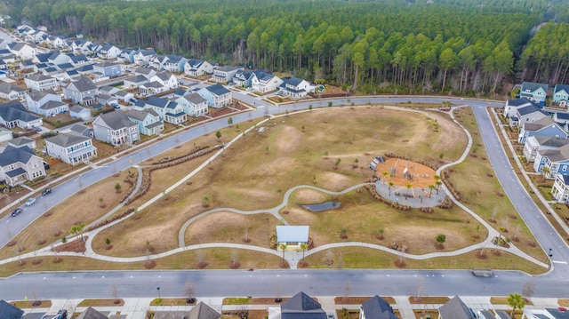 aerial view featuring a forest view and a residential view