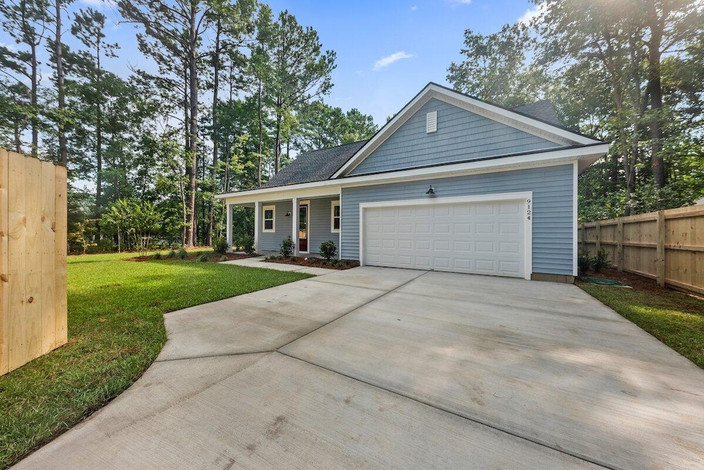 view of front of house with a garage and a front lawn