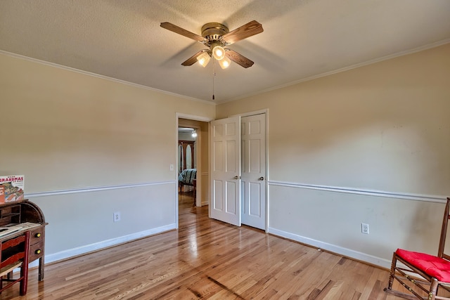 interior space featuring light wood-style floors, baseboards, and ornamental molding